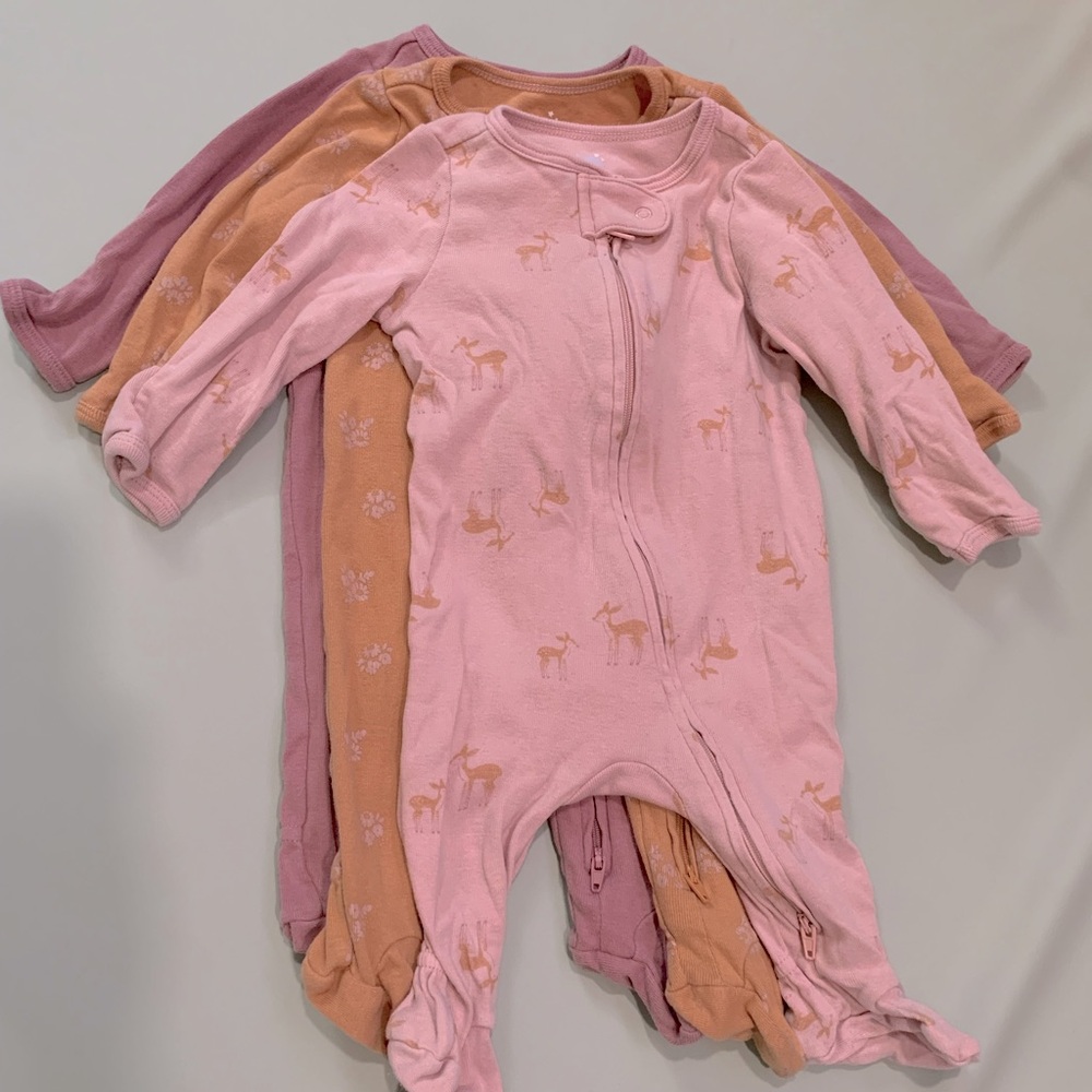 A bundle of Cloud Island onesie bodysuits in size 0-3 months.